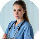 A healthcare professional in scrubs in a modern medical office, representing healthcare loan expertise.