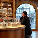 A vibrant and well-stocked retail store with a friendly cashier interacting with a customer, representing retail financing.